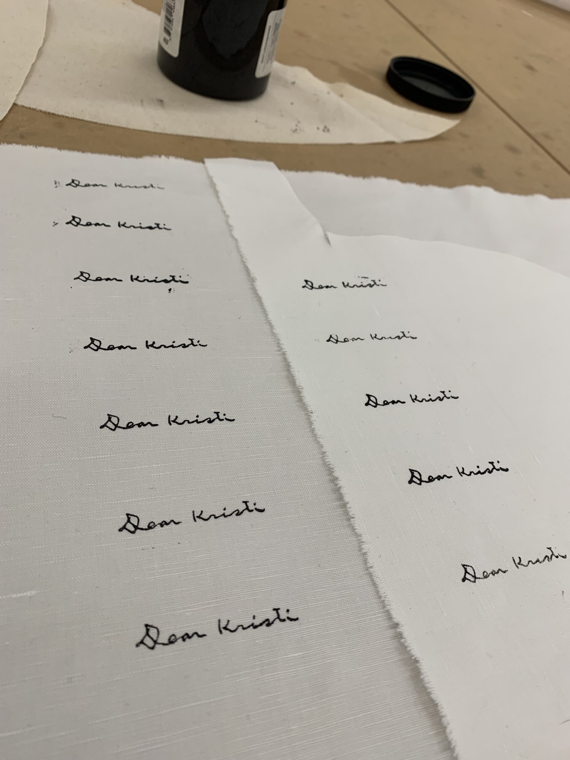 The brand’s logo is stamped with black ink onto white fabric. This was done using custom, laser-cut stamps.