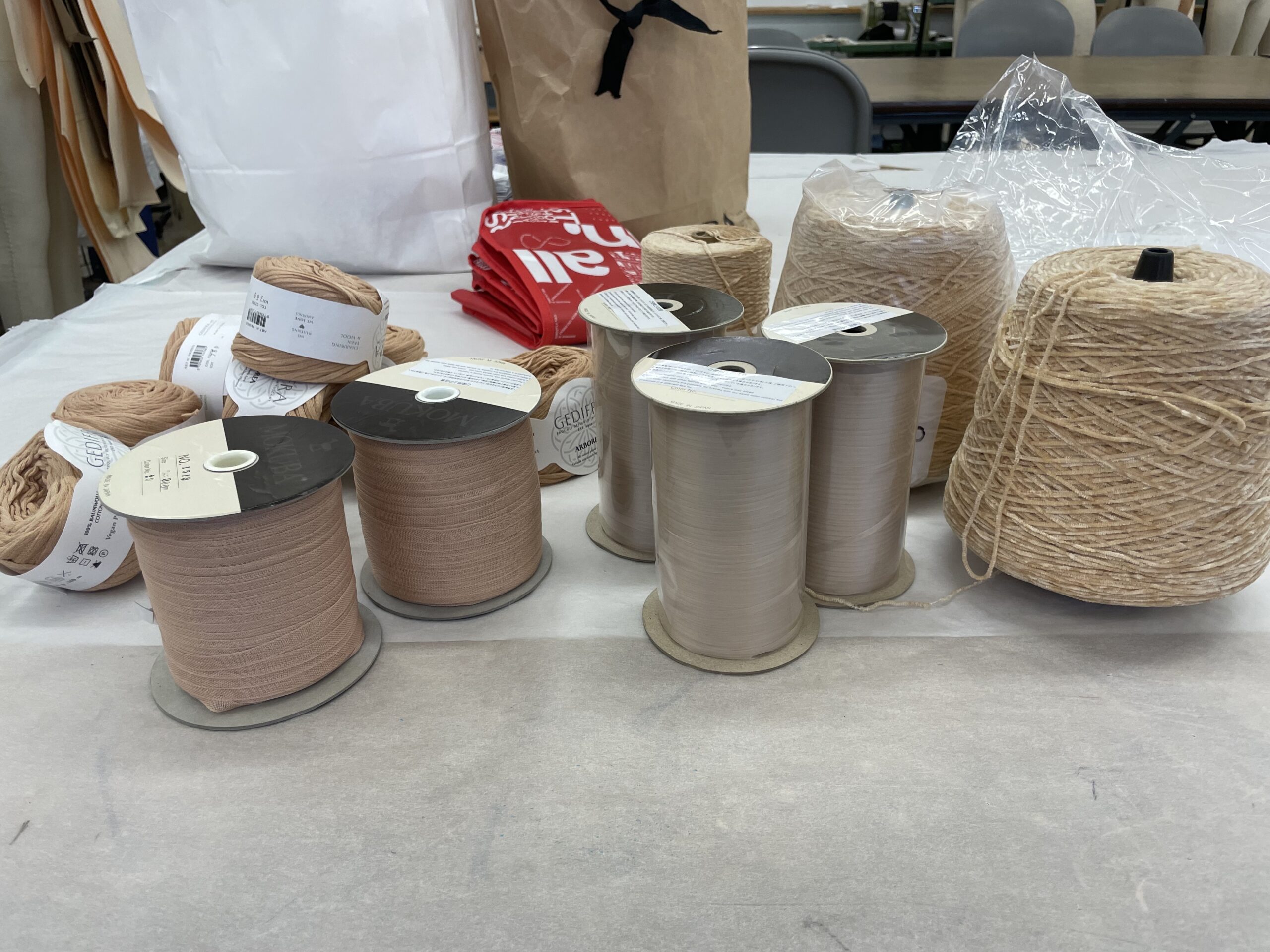 Collection of ribbons and yarns for crochet pieces